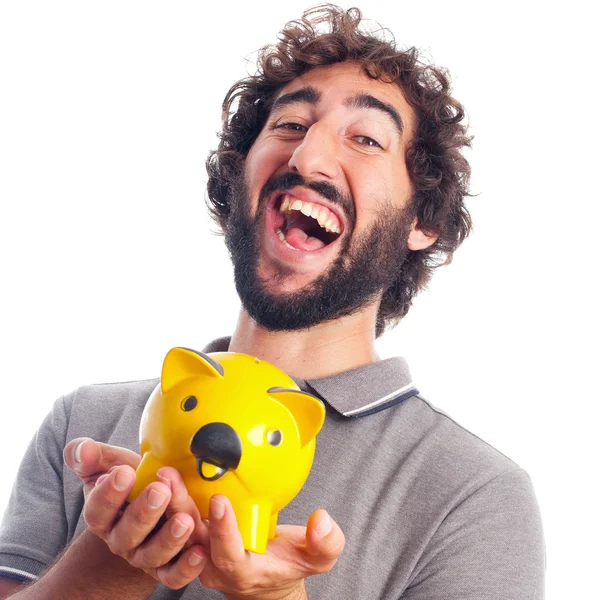 Jovem louco homem feliz com um porquinho banco — Fotografia de Stock