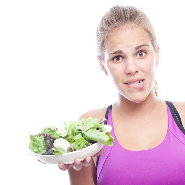 Wanita muda keren meragukan dengan donat dan salad — Stok Foto