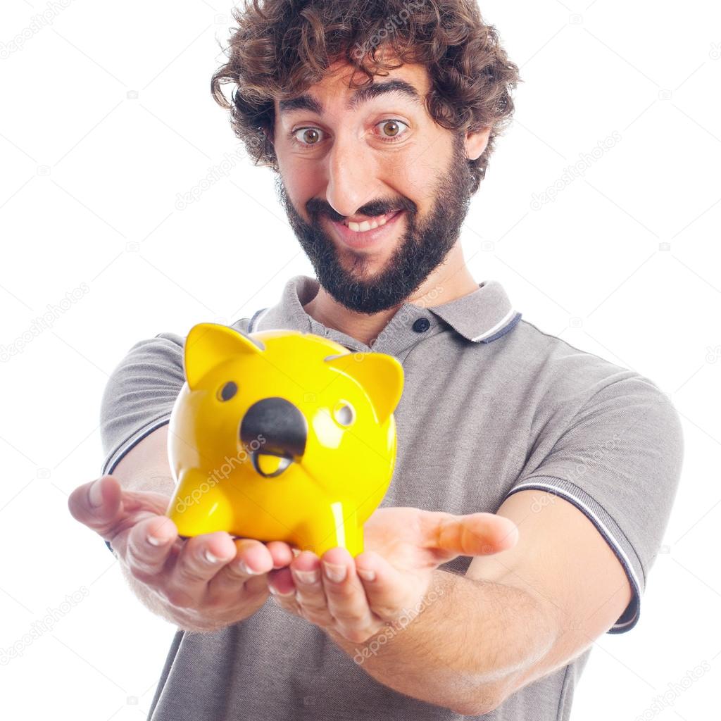 Young crazy man offering a piggy bank