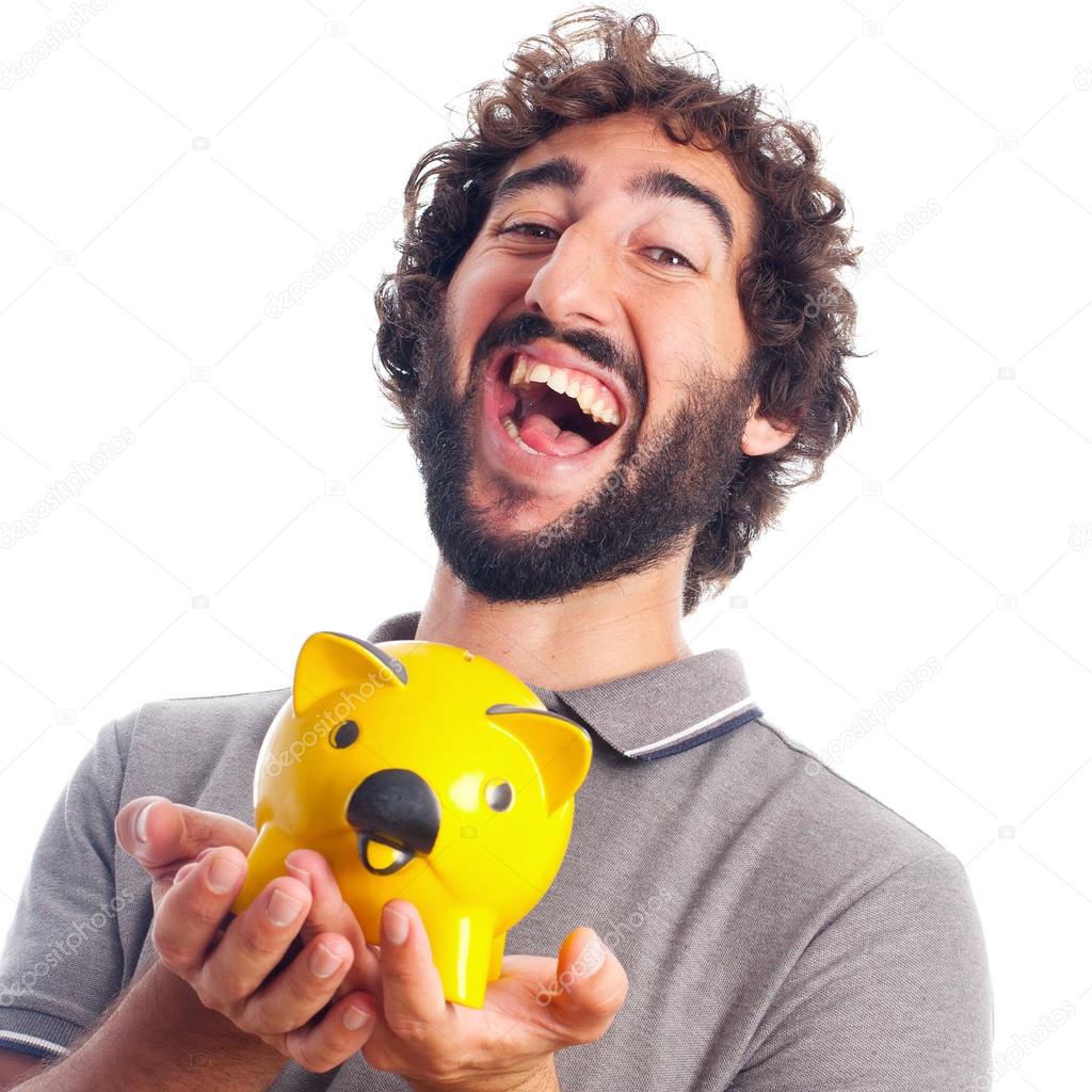Young crazy man happy with a piggy bank