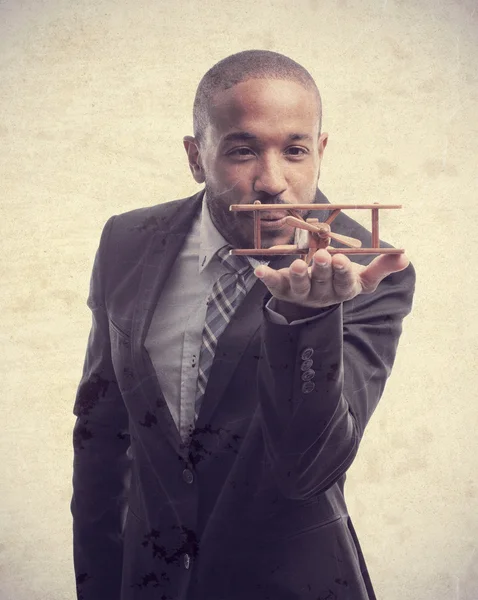 Young cool black man with wooden plane — Stock Photo, Image