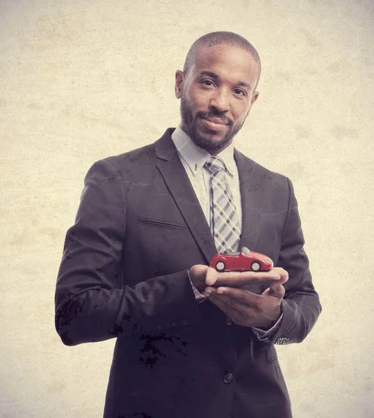 Jeune homme noir cool avec jouet de voiture — Photo