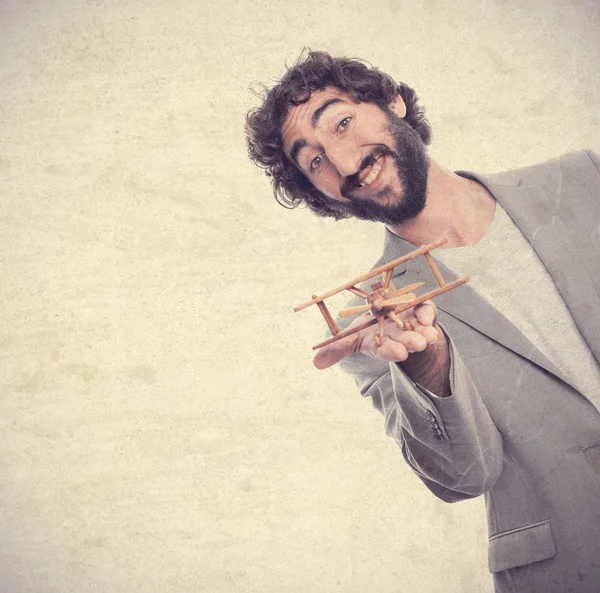 Joven loco con un avión de madera — Foto de Stock