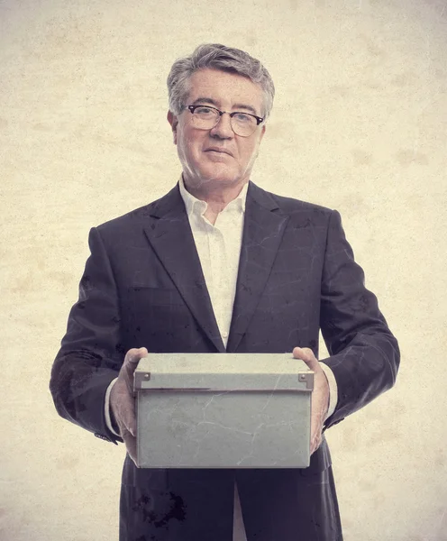 Senior cool man with a closed box — Stock Photo, Image