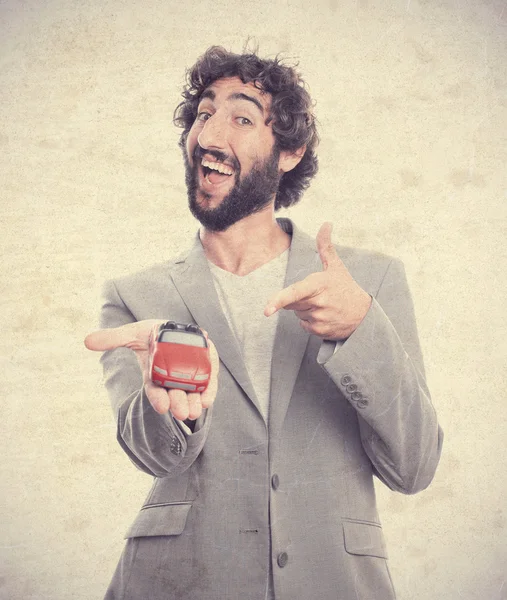 Young crazy man with a car toy — Stock Photo, Image