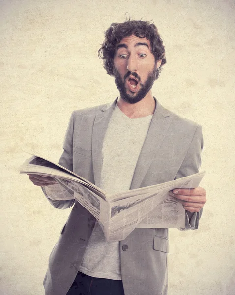 Young crazy man with a newspaper — Stock Photo, Image