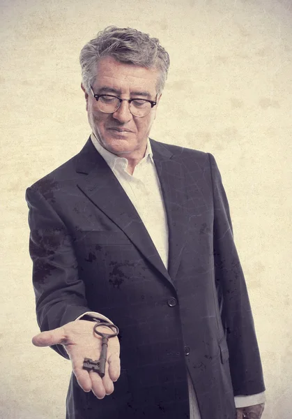 Senior cool man with an old key — Stock Photo, Image