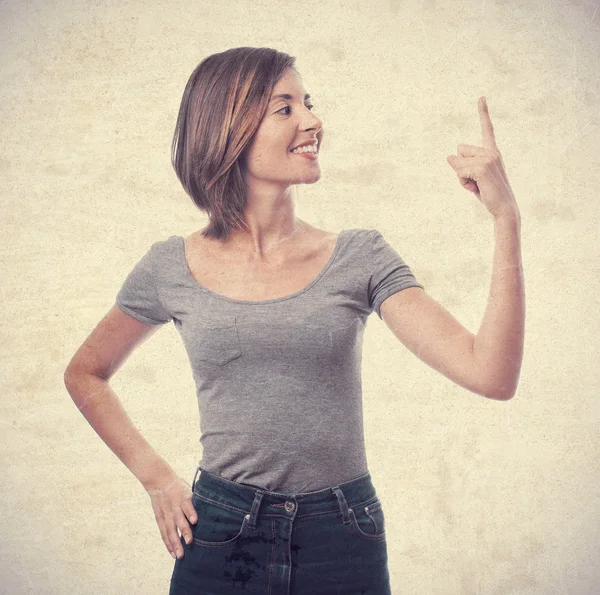 Young cool woman pointing up — Stock Photo, Image