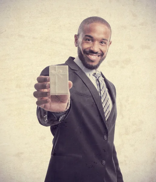 Young cool black man with giftbox — Stock Photo, Image