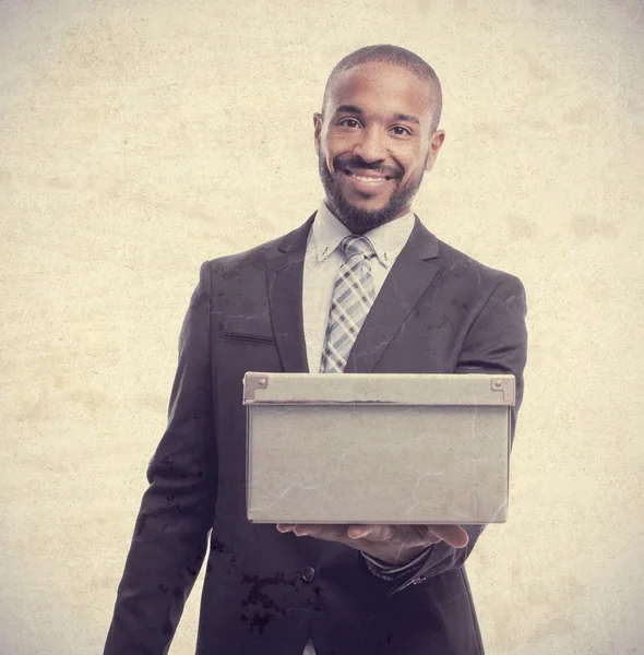 Young cool black man offering a box — Stock Photo, Image