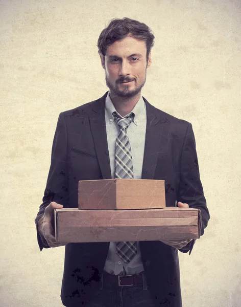 Young crazy businessman with boxes — Stock Photo, Image