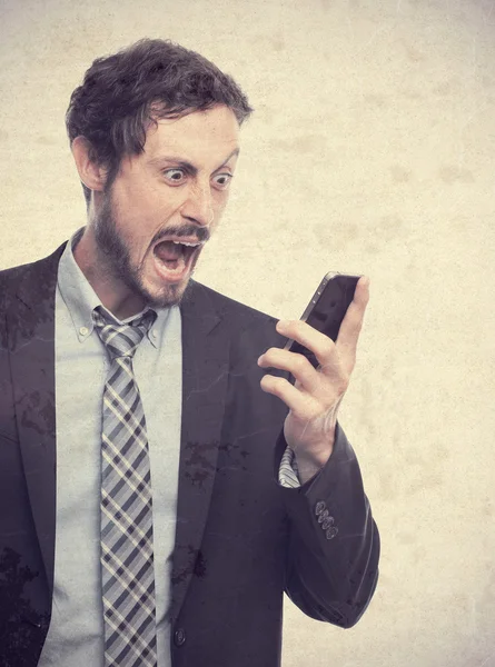 Young crazy businessman shouting on phone — Stock Photo, Image