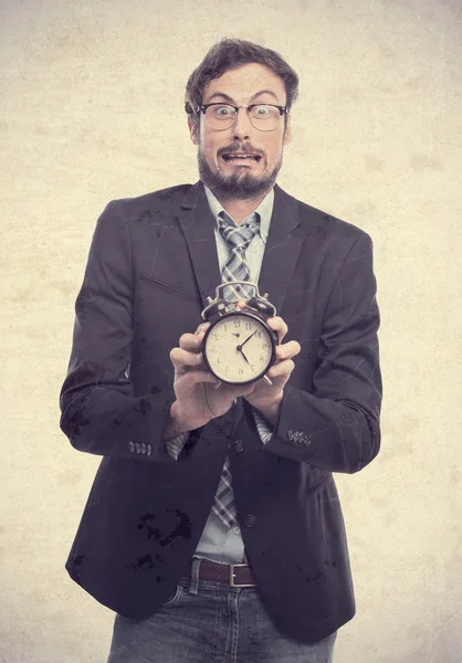 Young crazy businessman with an alarm clock — Stock Photo, Image