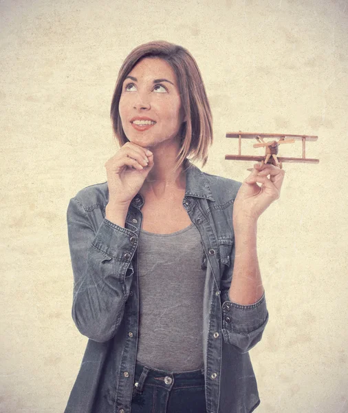 Young cool woman with wooden plane — Stock Photo, Image