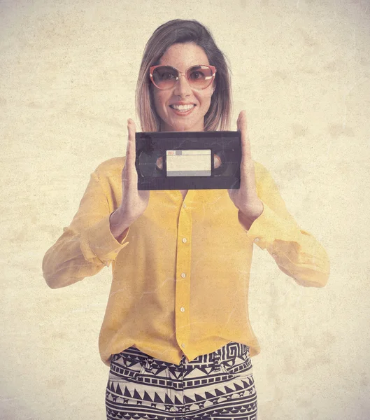 Young cool woman with a cassette — Stock Photo, Image