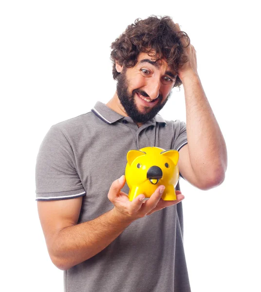 Young crazy man worried with a piggy bank — Stock Photo, Image