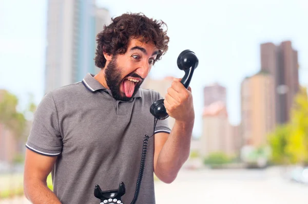 Young crazy man shouting at phone — Stock Photo, Image