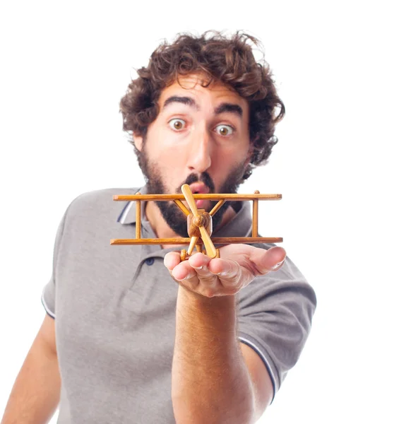 Young crazy man with a wooden plane — Stock Photo, Image