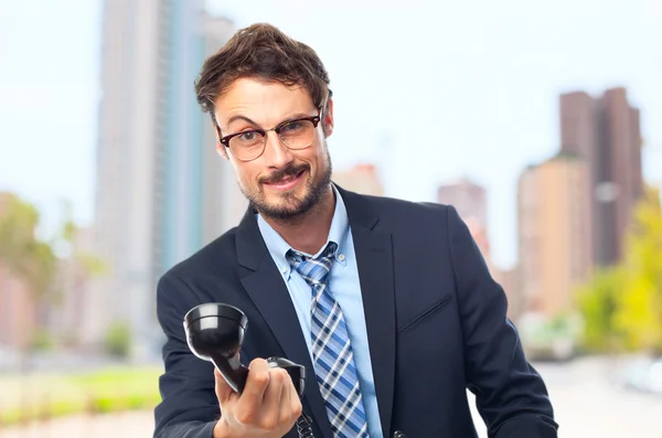 Young crazy businessman offering a phone — Stock Photo, Image