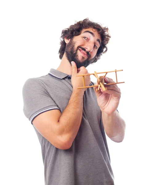 Young crazy man with a wooden plane — Stock Photo, Image