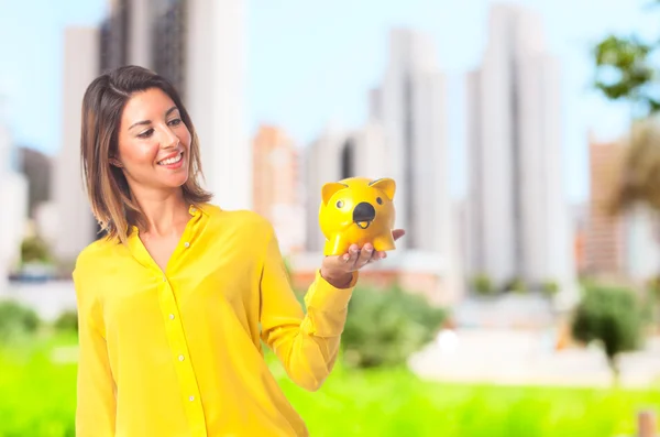 Young cool woman with piggy bank — Stock Photo, Image