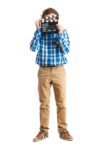 Teenager holding a clapperboard — Stock Photo, Image