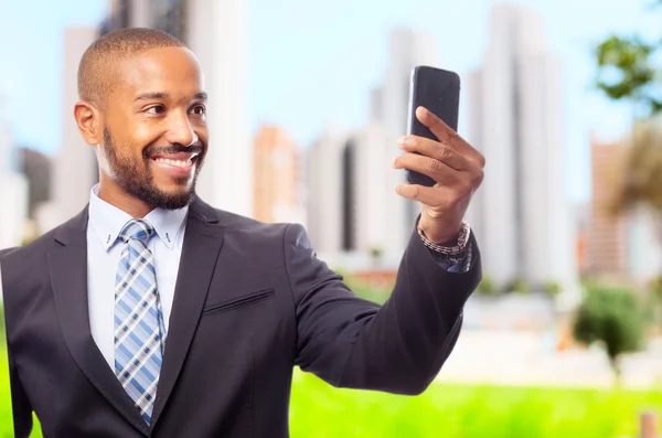 Young cool black man taking a picture with his phone — Stock Photo, Image