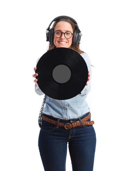 Chica joven con auriculares y sosteniendo un vinilo — Foto de Stock