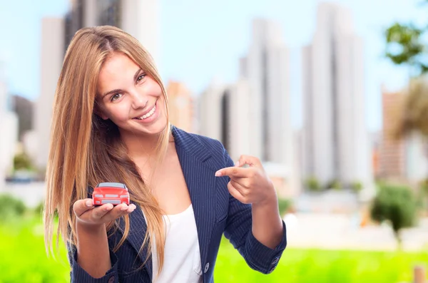 Young cool woman with car toy — Stock Photo, Image