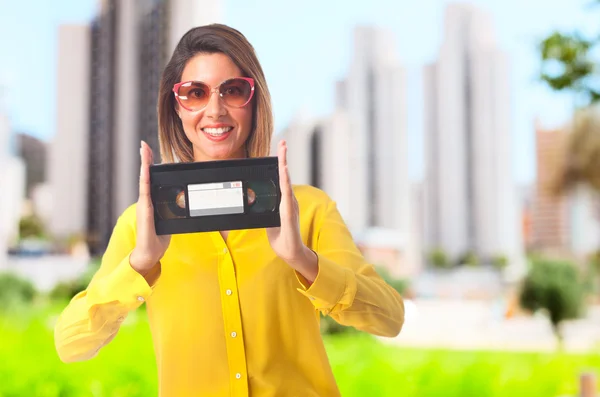 Young cool woman with a cassette — Stock Photo, Image