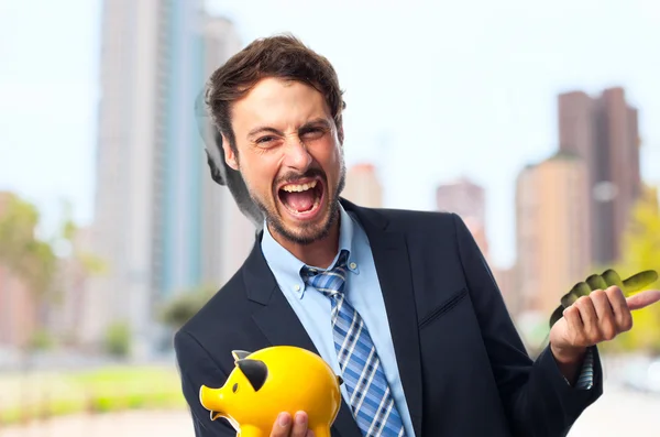 Jonge gek zakenman met een piggy bank — Stockfoto