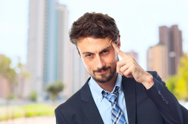Young crazy businessman intelligence gesture — Stock Photo, Image
