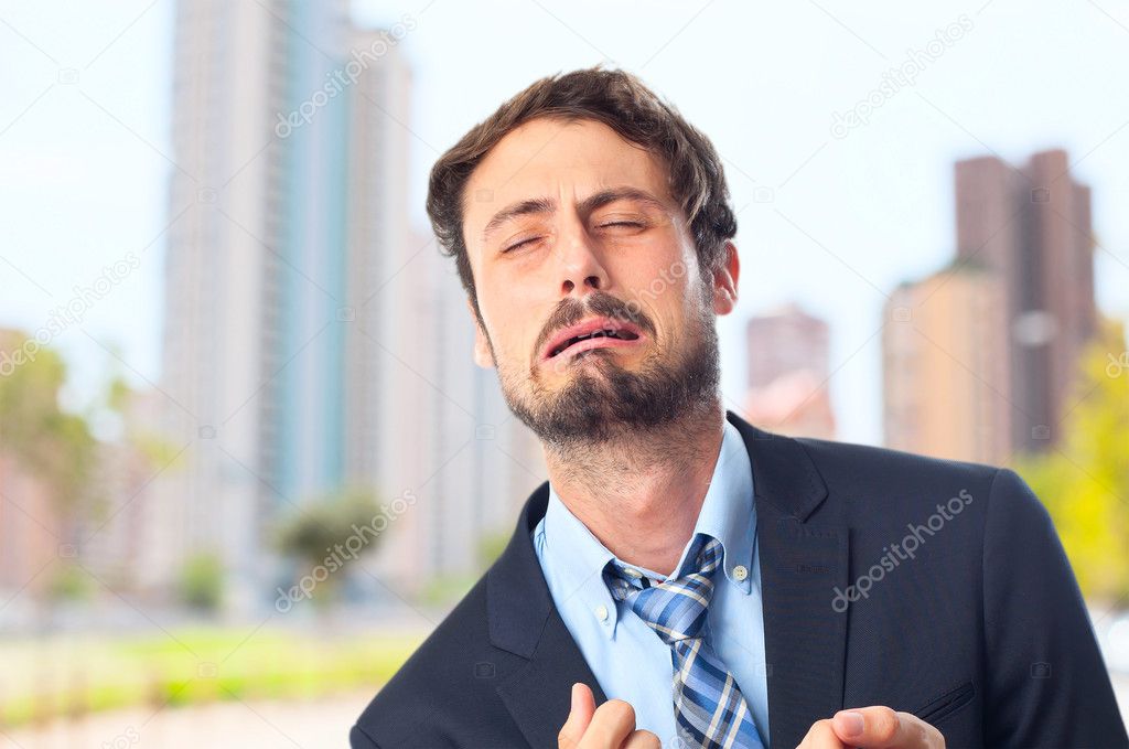 young crazy businessman crying