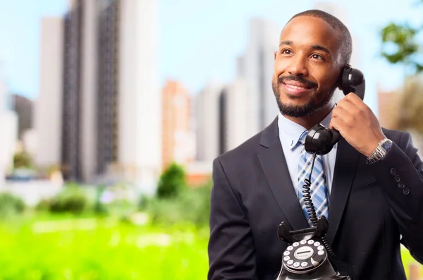 Young cool black man speaking at telephone — Stock Photo, Image