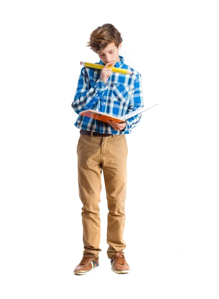 Teenager with pencil and holding a notebook — Stock Photo, Image