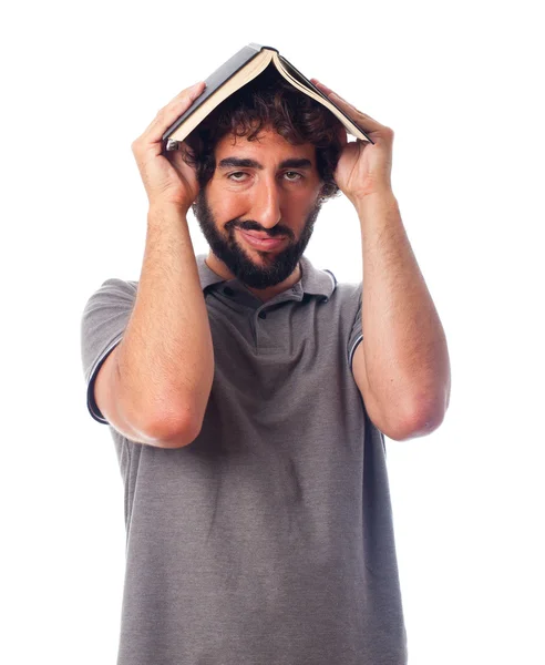 Young crazy man boring with a book — Stock Photo, Image