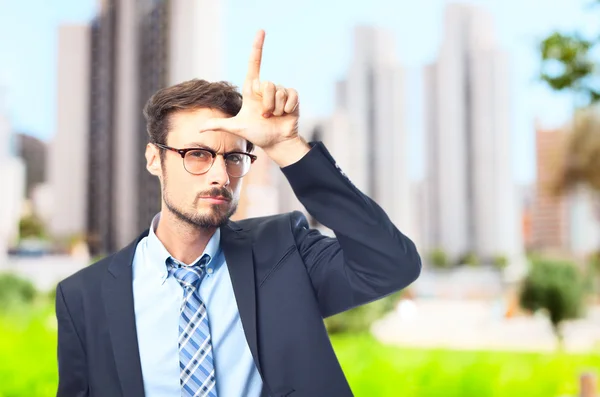 Young crazy businessman loser gesture — Stock Photo, Image