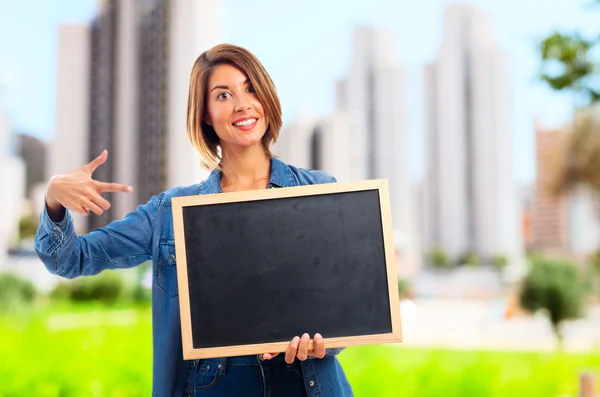 Young cool woman with a blackboard — Stock Photo, Image