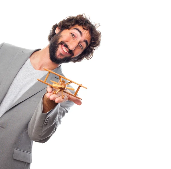Young crazy man with a wooden plane — Stock Photo, Image