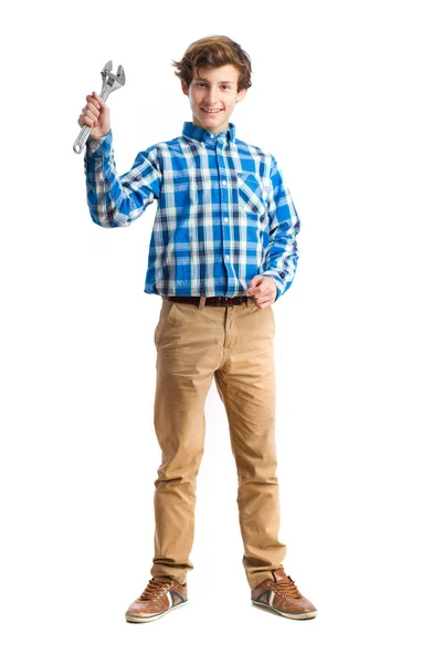 Teenager holding an ajustable wrench — Stock Photo, Image