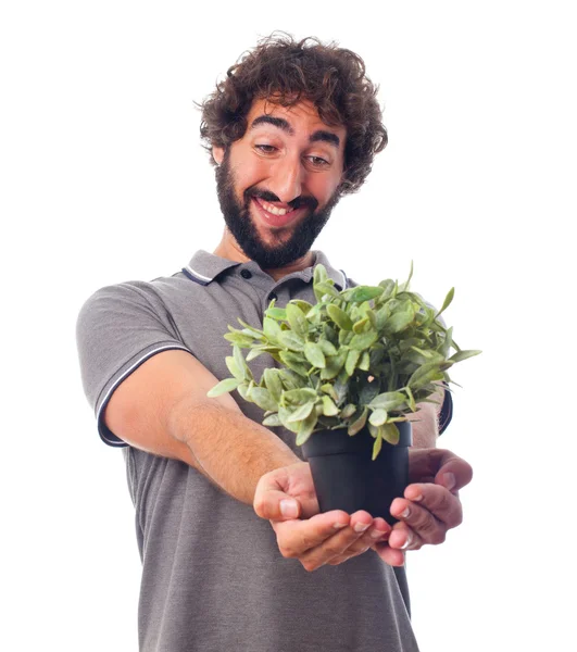 Gek jongeman met een plant — Stockfoto