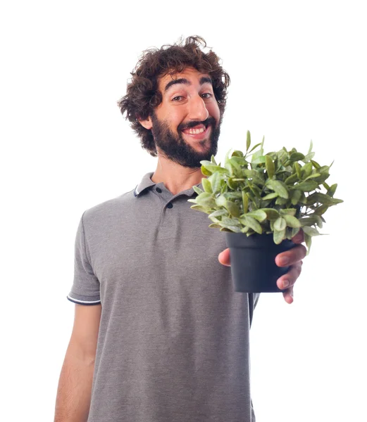 Jeune homme barbu avec une plante — Photo