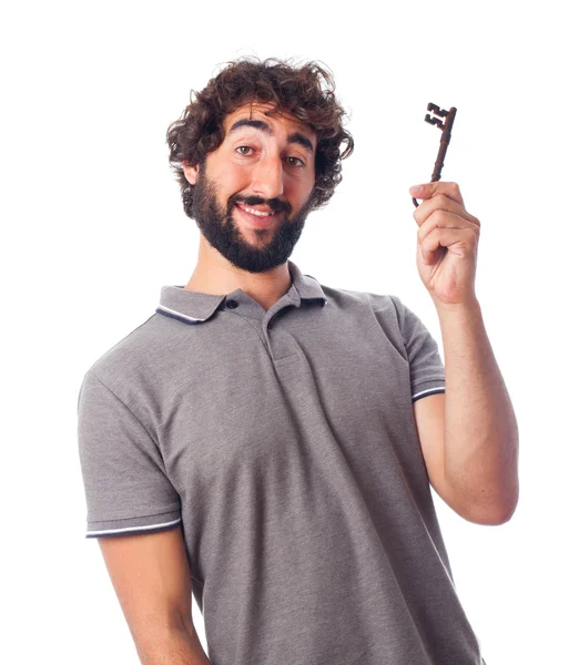 Young crazy man with an old key — Stock Photo, Image
