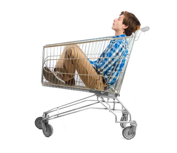 Teenager inside a shopping cart Royalty Free Stock Images