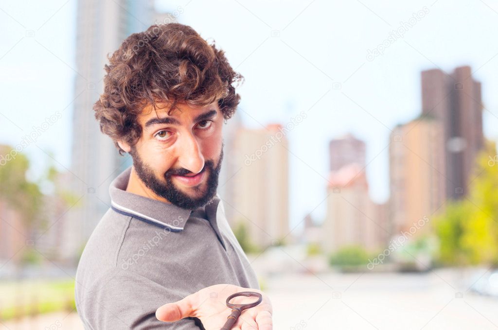 young crazy man offering an old key