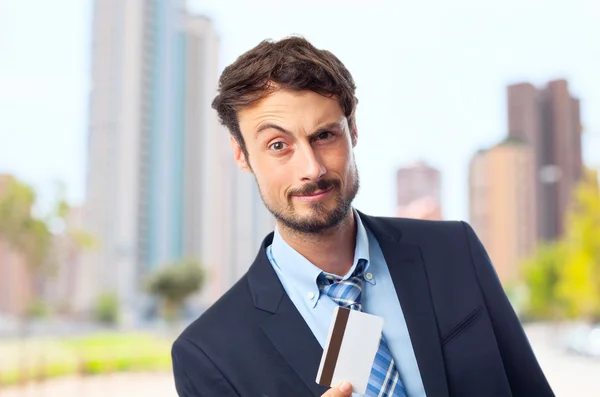 Young crazy businessman with a credit card — Stock Photo, Image