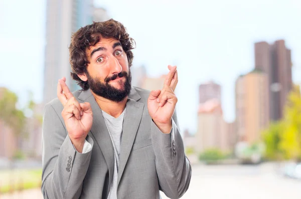 Young crazy man finger crossing — Stock Photo, Image