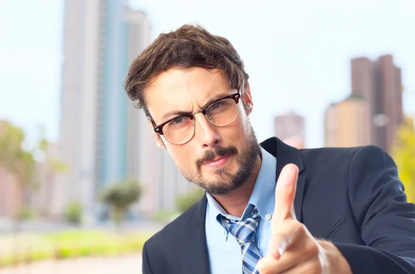 Young crazy businessman pointing — Stock Photo, Image