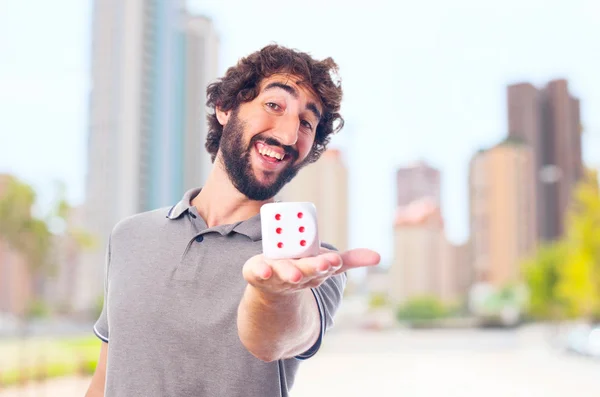 Joven loco con un dado. concepto de suerte —  Fotos de Stock