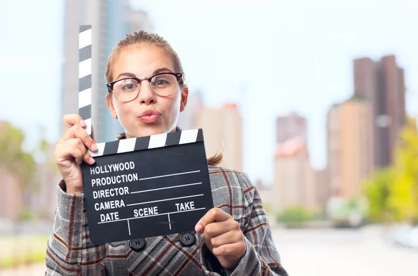 stock image young cool woman with a clapperboard